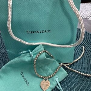 Tiffany & Co. Silver Beaded Necklace with Heart Charm. $450.00